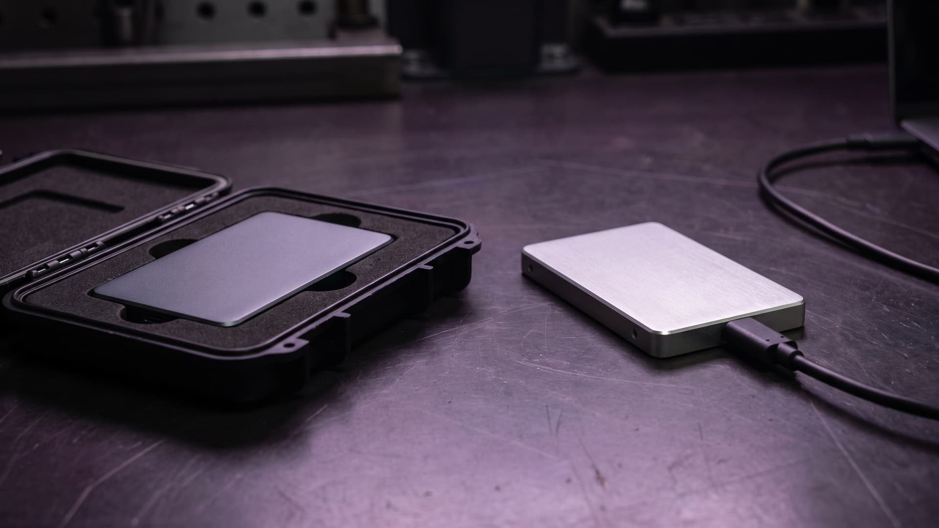 A protected original storage drive beside a connected replacement drive, illustrating a carefully verified EHR migration.